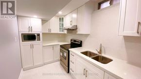 Richmond Hill (Devonsleigh) apartment for rent - A kitchen with white cabinets and a stove top oven.