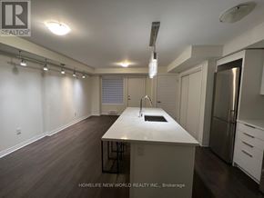 Toronto (Downsview-Roding-Cfb) townhouse for rent - A kitchen with a white countertop and stainless steel appliances.
