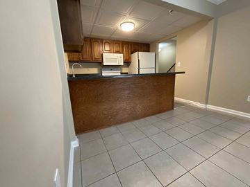 High Point apartment for rent - A kitchen with a white fridge and microwave above a counter.