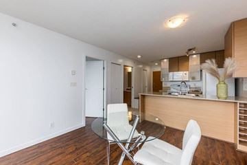 Vancouver apartment for rent - A modern kitchen with a glass table and white chairs.