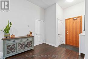 Niagara Falls (Mt. Carmel) condo for rent - A room with a grey cabinet and a wooden door.
