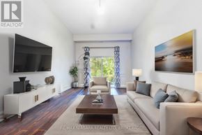 Niagara Falls (Mt. Carmel) condo for rent - A living room with a television, couches, and a coffee table.