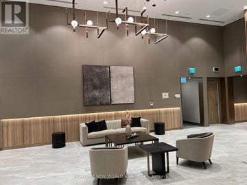 Toronto (York University Heights) condo for rent - A modern living room with a large painting on the wall and a coffee table in the center.