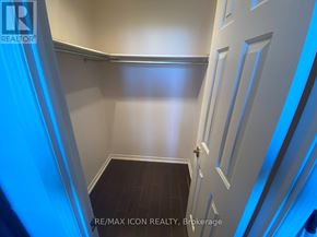 London East (East F) condo for rent - A hallway with a wooden floor and white walls.