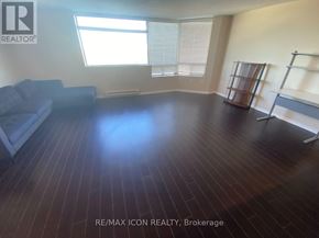 London East (East F) condo for rent - A room with wooden flooring and a couch.