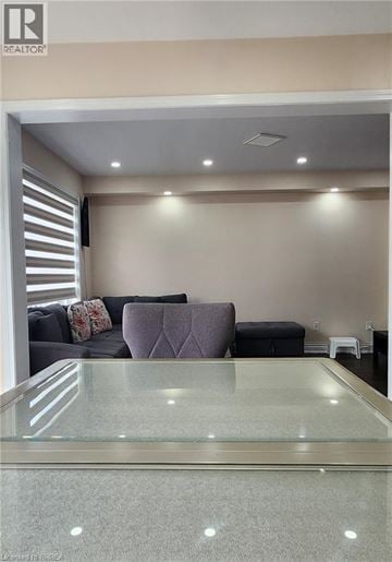 Brantford townhouse for rent - A living room with a glass table and a grey couch.