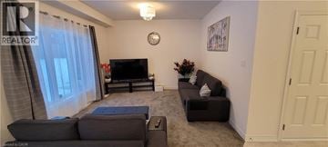 Collingwood apartment for rent - A living room with a grey couch and a black television.