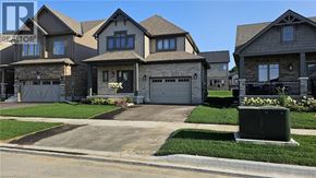 Collingwood apartment for rent - A large, modern house with a stone wall and a garage door.
