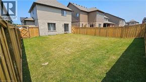 Collingwood apartment for rent - A backyard with a wooden fence and a grassy area.