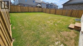 Collingwood apartment for rent - A backyard with a wooden fence and a green lawn.
