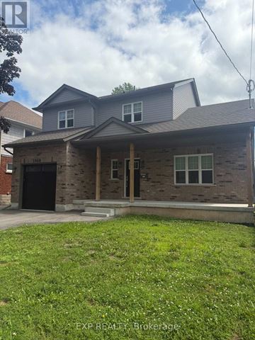 Niagara Falls (Dorchester) apartment for rent - A house with a grey roof and a brick wall is for sale.