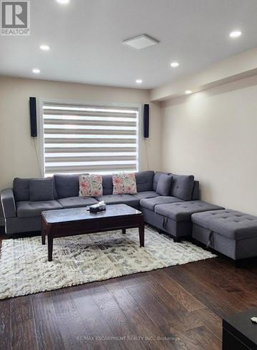 Brantford townhouse for rent - A living room with a grey sofa and a wooden coffee table.