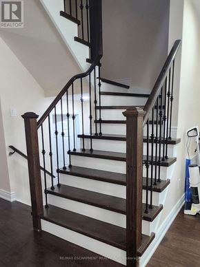 Brantford townhouse for rent - A staircase with a wooden handrail and black balusters.