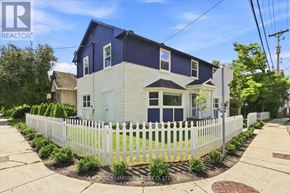 Ottawa apartment for rent - A blue and white house with a white picket fence in front.