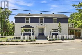 Ottawa apartment for rent - A two-story house with a white picket fence in front.