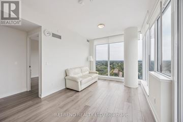 Toronto (Willowdale West) condo for rent - A living room with a white couch and a large window.