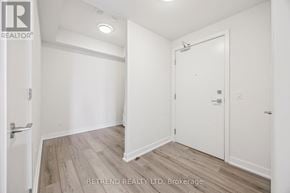 Toronto (Willowdale West) condo for rent - A white room with a door and a brokerage sign.