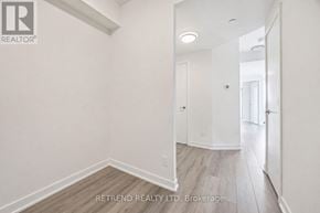Toronto (Willowdale West) condo for rent - A white hallway with wood flooring and a mirror on the wall.