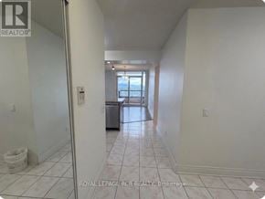 Toronto (Willowdale East) condo for rent - A white hallway with a door on the left and a window on the right.
