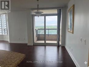 Toronto (Willowdale East) condo for rent - A room with a view of the ocean through a sliding glass door.