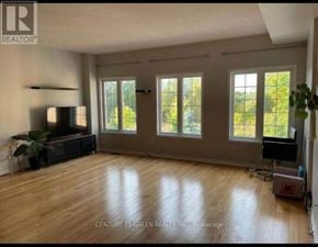 Toronto (Scarborough Village) apartment for rent - A spacious living room with wooden floors and a flat-screen TV.