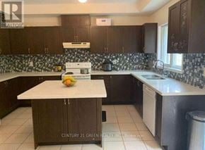 Toronto (Scarborough Village) apartment for rent - A kitchen with a white counter top and brown cabinets.