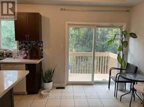 Toronto (Scarborough Village) apartment for rent - A kitchen area with a table and chairs and a sliding glass door.