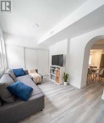 Kitchener triplex for rent - A living room with a grey couch and a television.