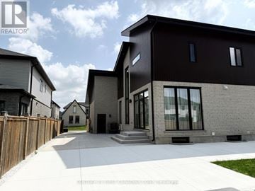 London South (South V) apartment for rent - A modern house with a black exterior and a wooden fence in front.