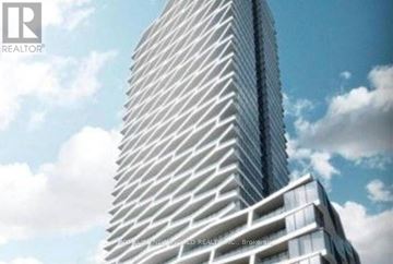 Toronto (Church-Yonge Corridor) condo for rent - A tall, modern building with a unique, angular design is depicted in the image.