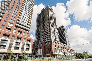 Toronto (Humber Heights) condo for rent - A construction site with a partially completed tall building in the background and a red building in the foreground.