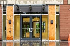 Toronto (Humber Heights) condo for rent - The front door of a building with a sign that reads "RE/MAX Key 2 Real Estate Brokerage.".