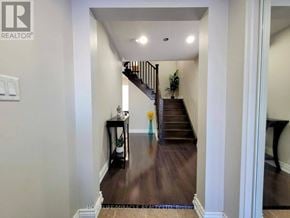 Brampton (Northwest Brampton) townhouse for rent - A hallway with a staircase and a plant on the side table.
