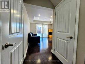 Brampton (Northwest Brampton) townhouse for rent - A hallway with a black bench and white doors.