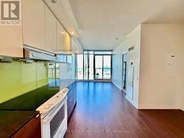 Toronto (Bayview Village) condo for rent - A kitchen with a stove top oven and a window.