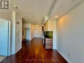Toronto (Bayview Village) condo for rent - A long hallway with wood floors and white walls.