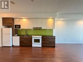 Toronto (Bayview Village) condo for rent - A kitchen with white appliances and a green backsplash.