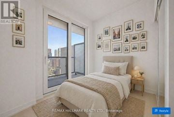 Toronto (Church-Yonge Corridor) condo for rent - A bedroom with a large bed and pictures on the wall.