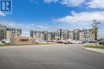 Milton (Be Beaty) condo for rent - A brokerage sign is in front of apartment buildings.