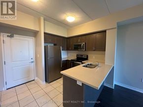 Milton (Be Beaty) condo for rent - A kitchen with a refrigerator, microwave, and oven.