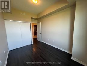 Milton (Be Beaty) condo for rent - A room with a white wall and a wooden floor.