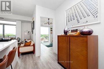 Toronto (Little Portugal) condo for rent - A modern living room with a brown chair and a brown cabinet.
