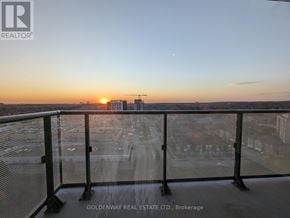 Richmond Hill (Langstaff) condo for rent - A sunset view from a balcony with a railing.