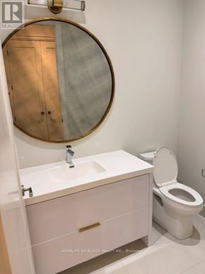 Markham (Unionville) condo for rent - A white bathroom with a round mirror and a sink with a cabinet underneath it.