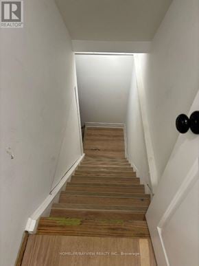 Newmarket (Huron Heights-Leslie Valley) apartment for rent - A long hallway with wooden floors and white walls.