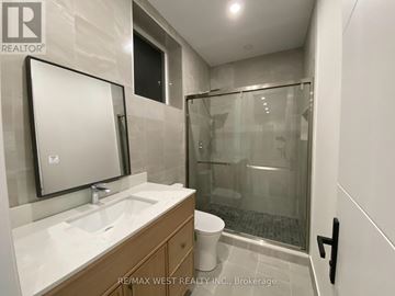 Toronto (Humberlea-Pelmo Park) apartment for rent - A bathroom with a sink, mirror, and shower.