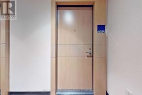 Toronto (Bay Street Corridor) condo for rent - A wooden door with a blue sign on it.