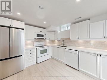 Vaughan (Maple) apartment for rent - A modern kitchen with white cabinets and stainless steel appliances.