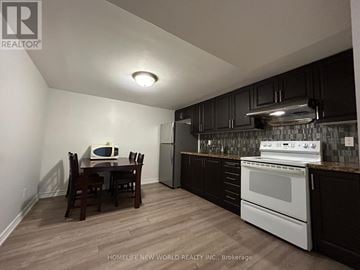 Markham (Milliken Mills West) apartment for rent - A kitchen with a table and chairs in the foreground and a stove top oven in the background.