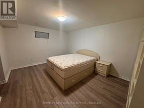 Markham (Milliken Mills West) apartment for rent - A bedroom with a bed, nightstand, and a window with blinds.